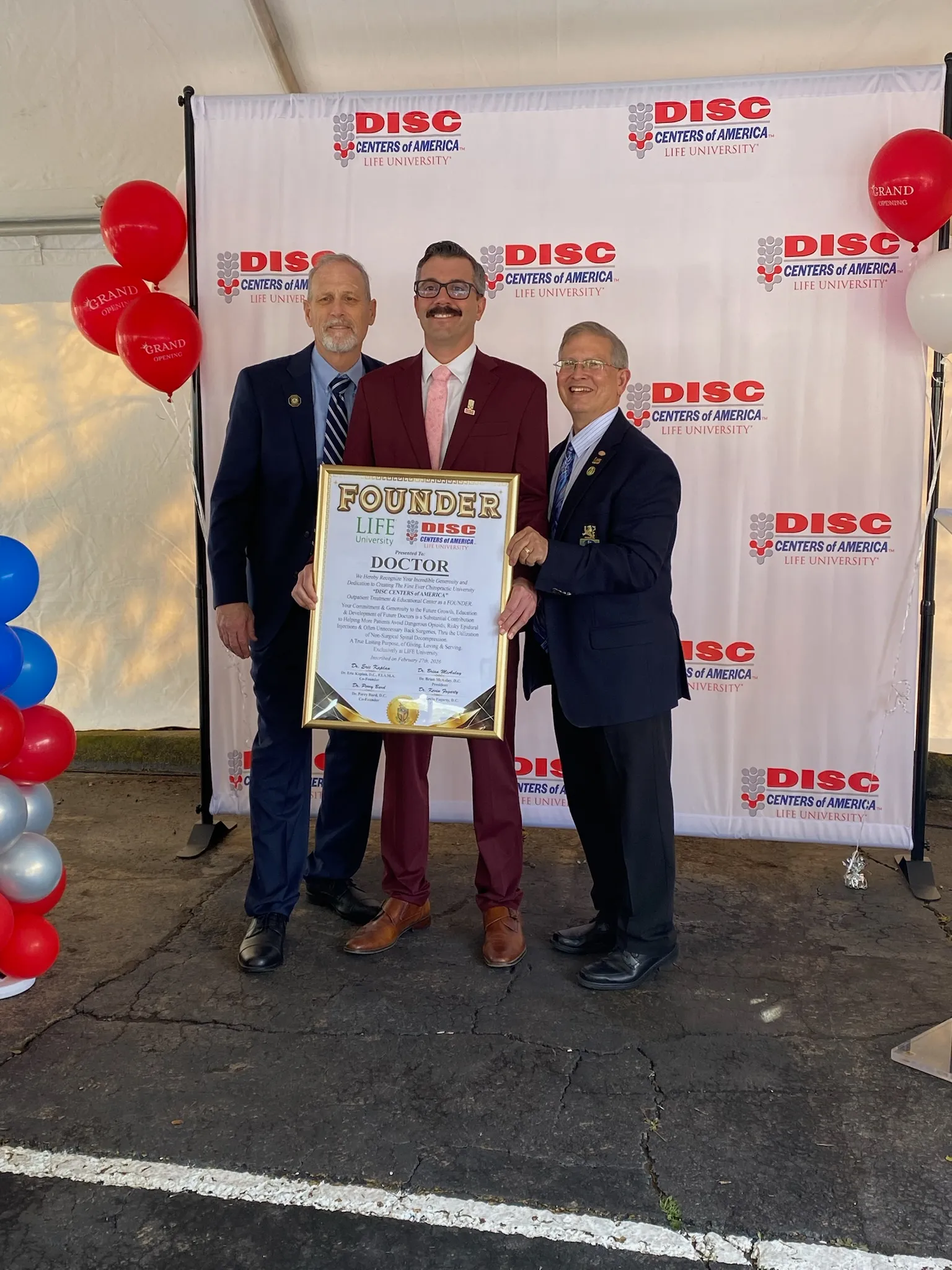 Dr. Krivolavek at a Disc Centers of America award event
