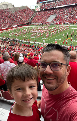 Dr. Krivolavek with his son at a Nebraska football game